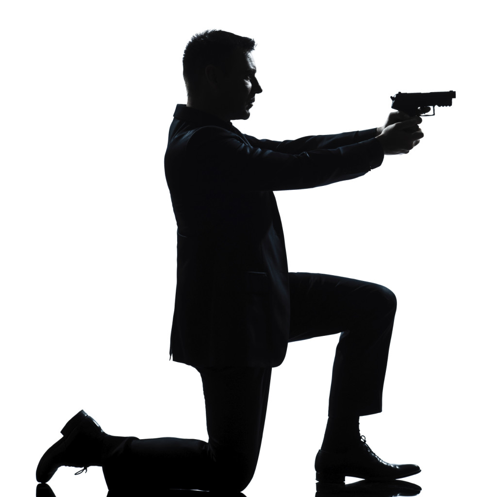 silhouette man kneeling aiming gun - Alabama Consumer Protection Lawyers